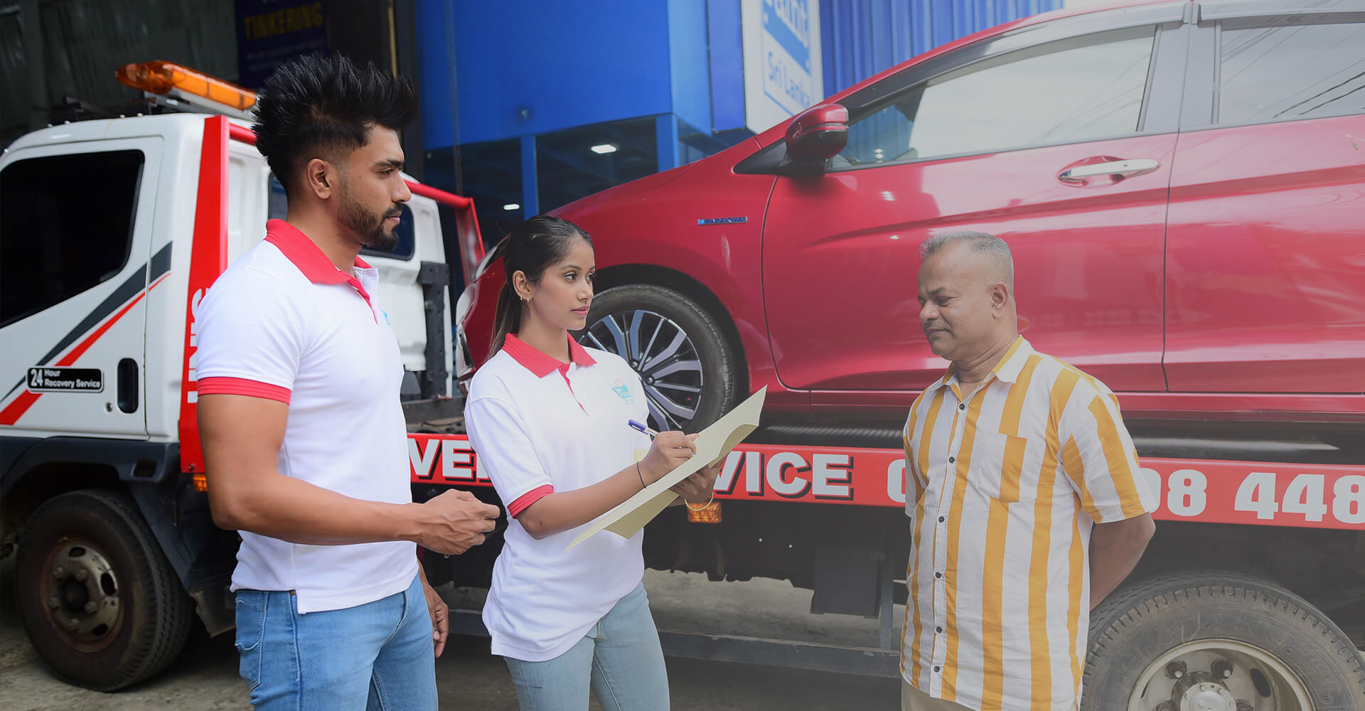 2 employees of Mr. Paint Auto gathering information from a client
