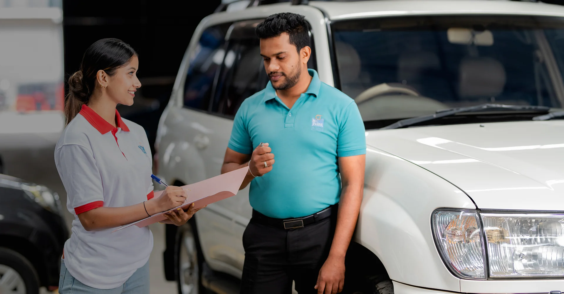 2 employees of Mr. Paint Auto having a discussion