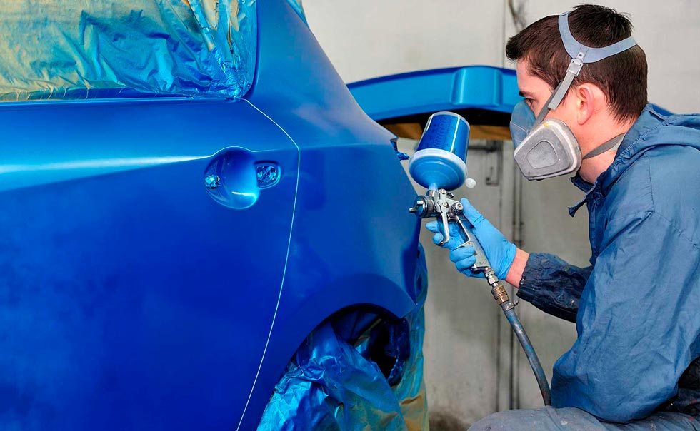 A man auto painting a car