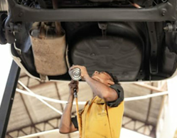 A man working on a vehicle repair at Mr. Paint Auto