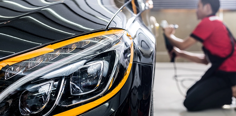 Mr. Paint Auto employee is detailing a car